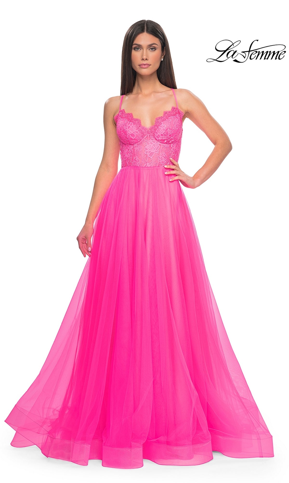 A woman models the La Femme Lace-Bodice Long A-Line Prom Dress 32306 in bright pink with thin straps, standing against a white background. The La Femme logo is displayed in the top right corner.